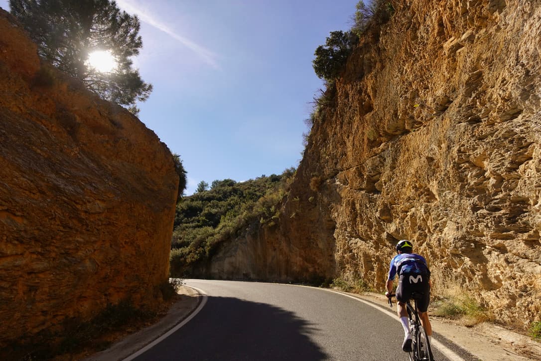 An athlete mid-session on a winding road